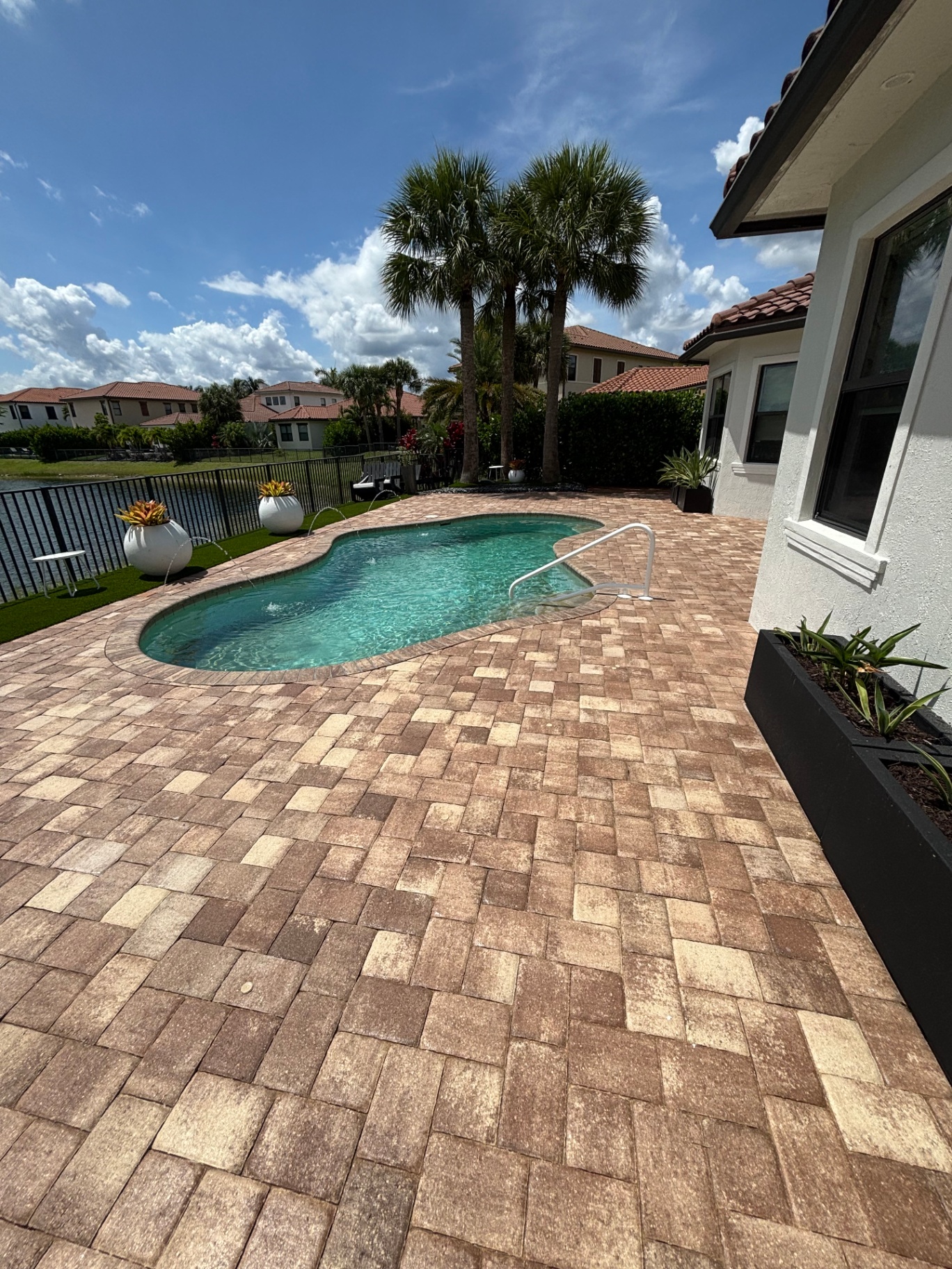 Sealed pool deck pavers with lake view