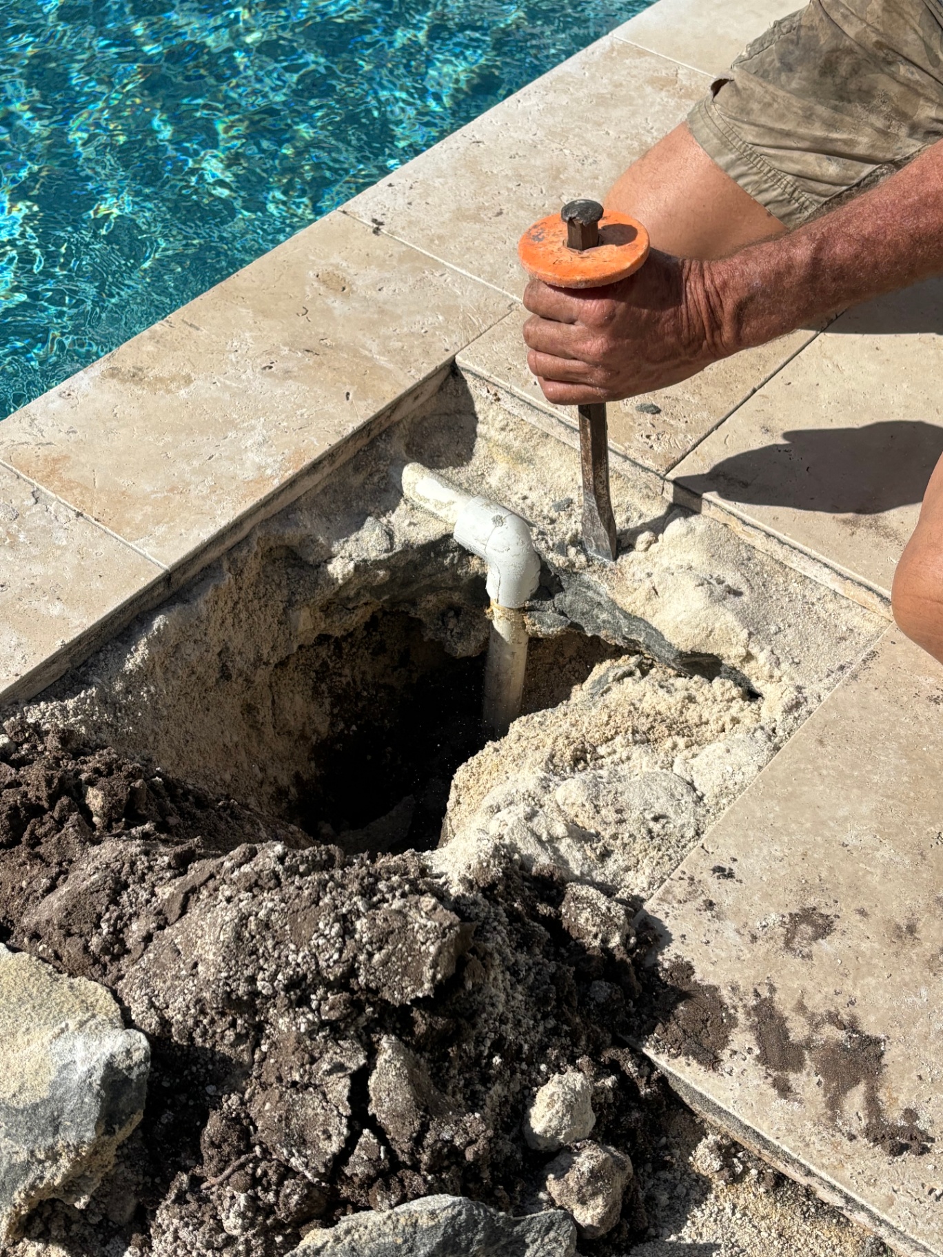 Aqua Touch technician repairing pool coping pavers in South Florida