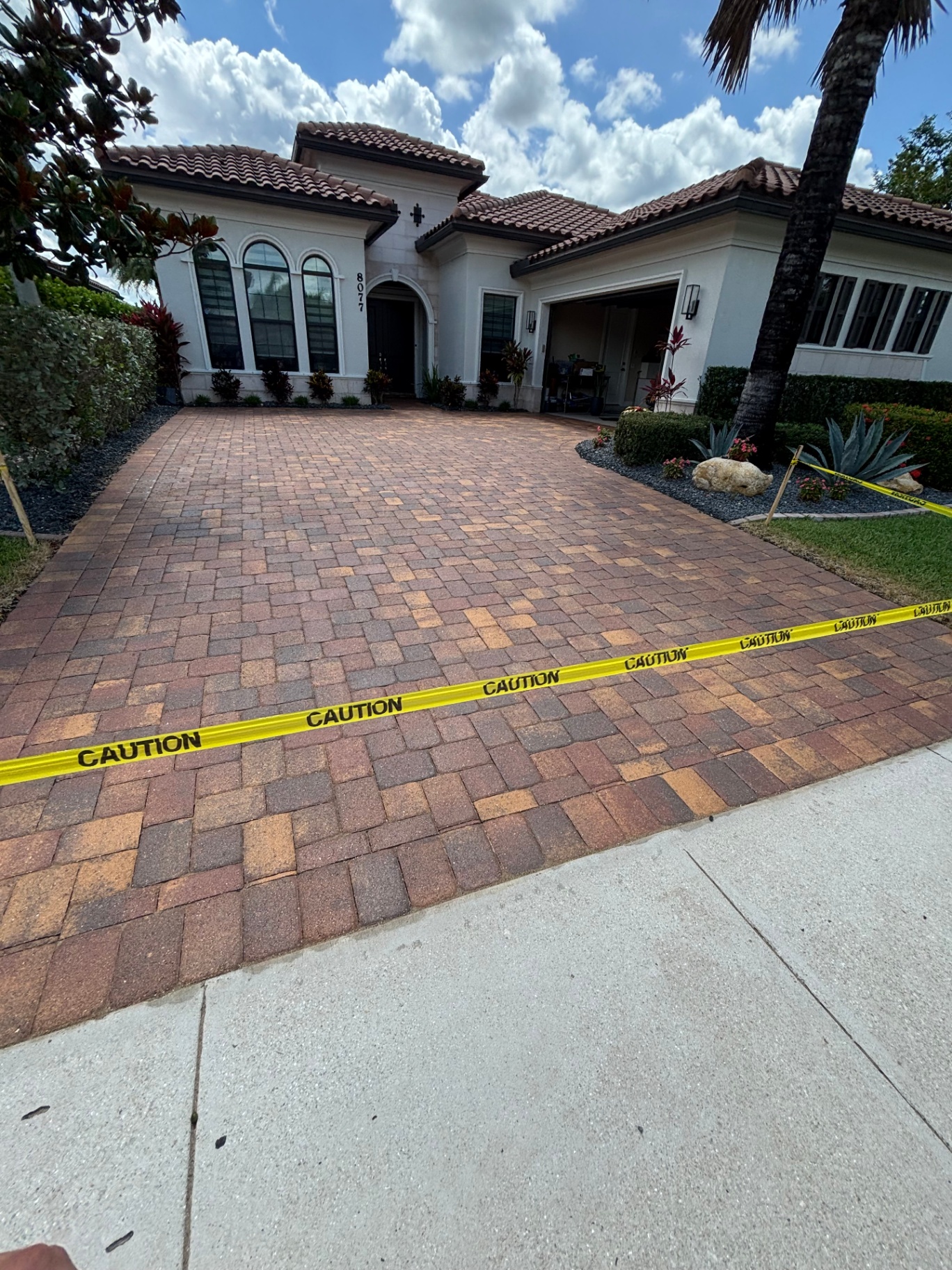 Freshly sealed paver driveway in Palm Beach County